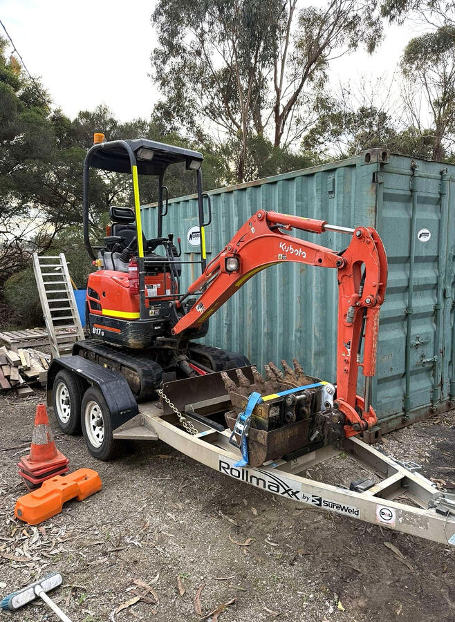 excavator digging trench - titan hire geelong